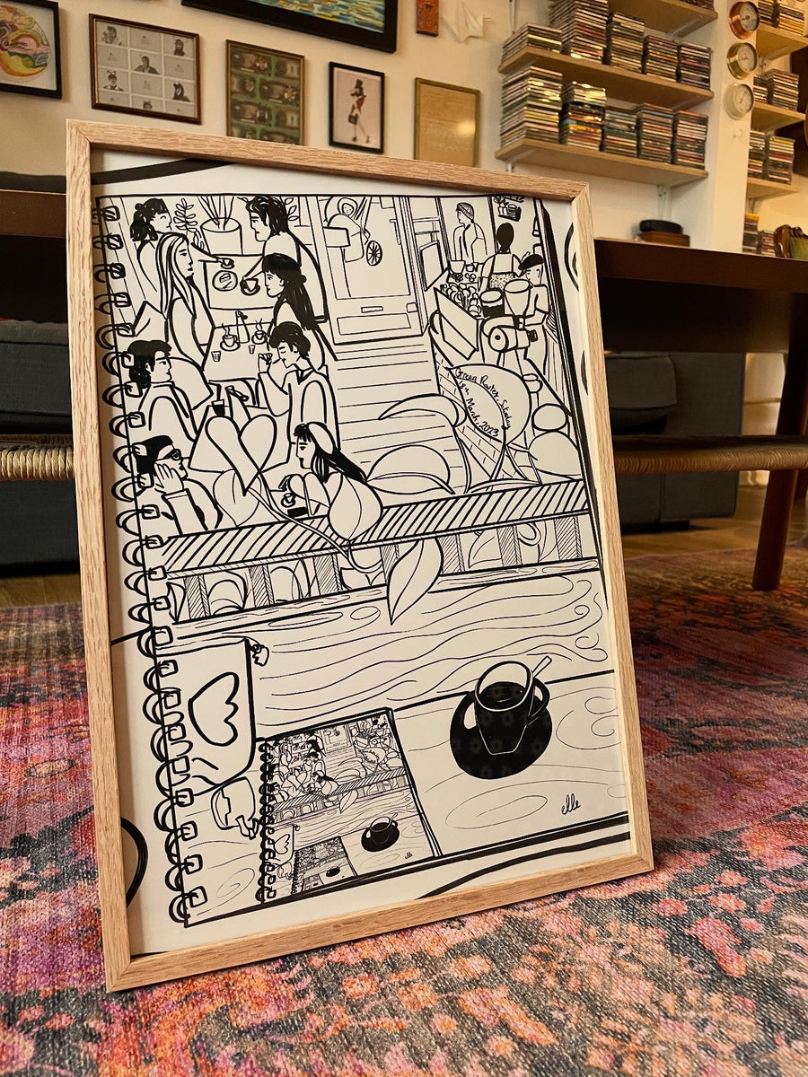 Framed black and white illustration of a cafe scene.