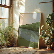 Framed landscape painting on a wall with plants around