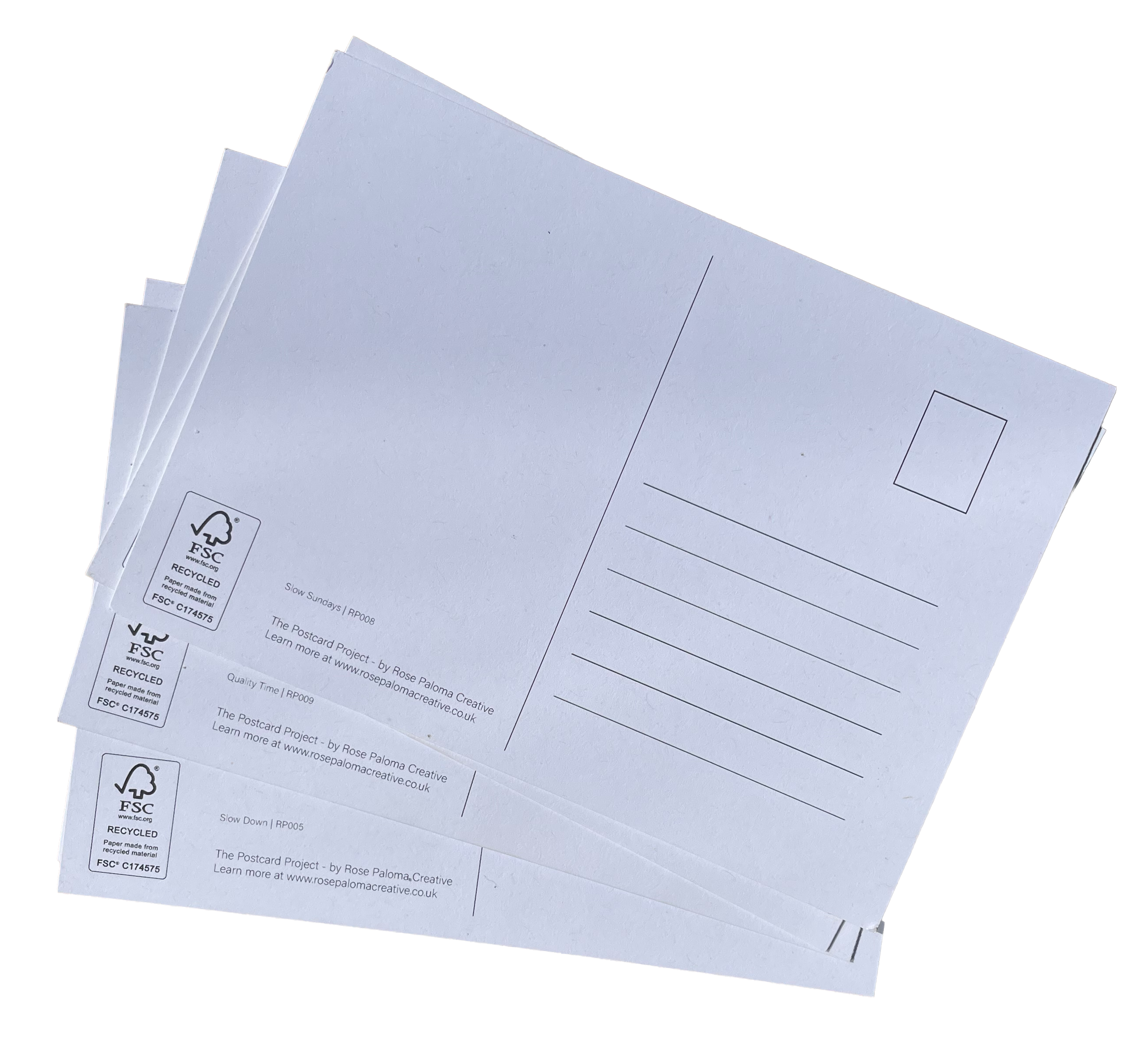A stack of white postcards with printed address lines, a rectangular return address label, and recycling icons on the left edge, photographed on a plain white background.