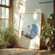 Framed artwork of a surfer on a beach in a sunlit room with plants